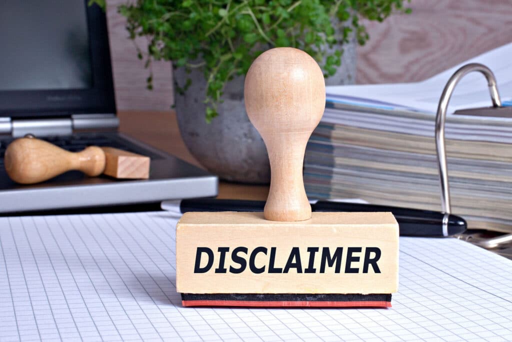 Disclaimer stamp on desk with charts and books