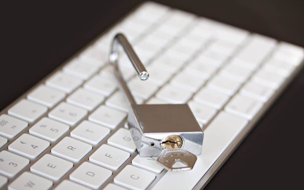 Padlock on computer keyboard symbolizing cybersecurity concept